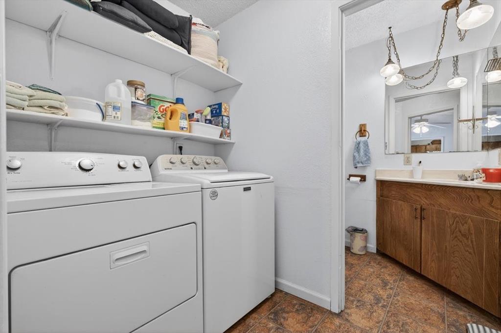 1706 Hitching Post Road Granbury, TX 76049 - Photo 15 of 40 a utility room with dryer and washer