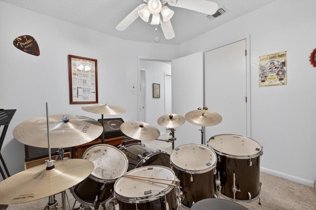 1706 Hitching Post Road Granbury, TX 76049 - Photo 21 of 40 a dining room with wooden floor a chandelier a glass table and chairs