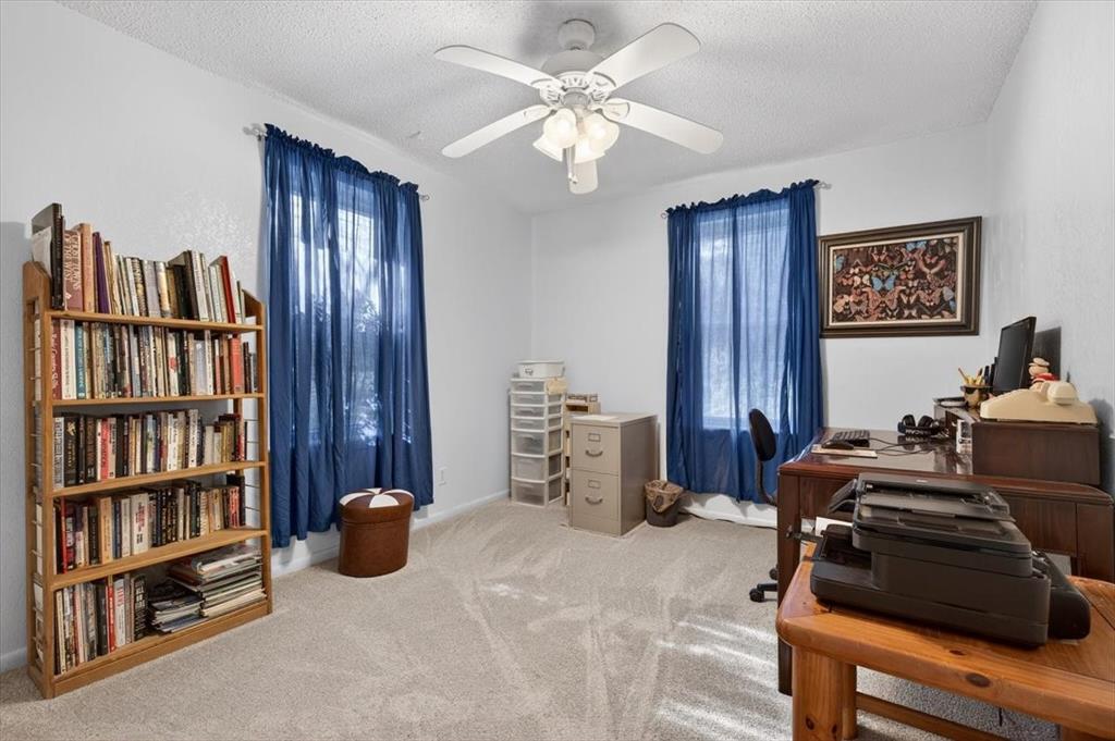 1706 Hitching Post Road Granbury, TX 76049 - Photo 22 of 40 a bedroom with furniture and a book shelf