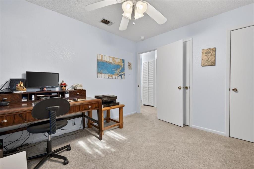 1706 Hitching Post Road Granbury, TX 76049 - Photo 24 of 40 a view of a workspace with furniture and a ceiling fan