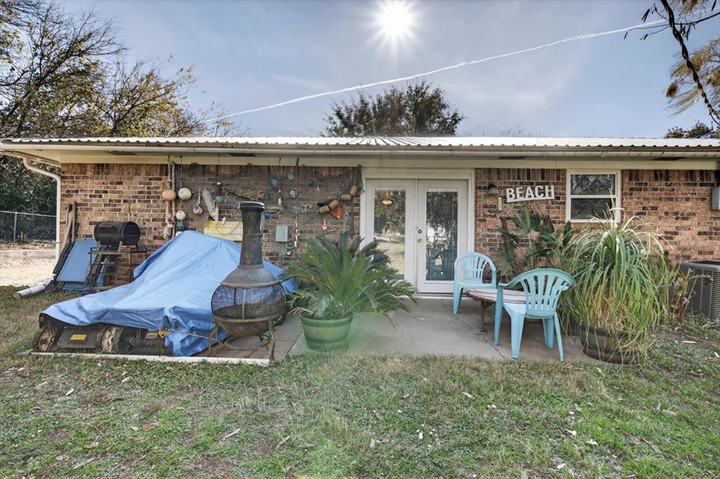 1706 Hitching Post Road Granbury, TX 76049 - Photo 25 of 40 a view of a chair and table in backyard of the house