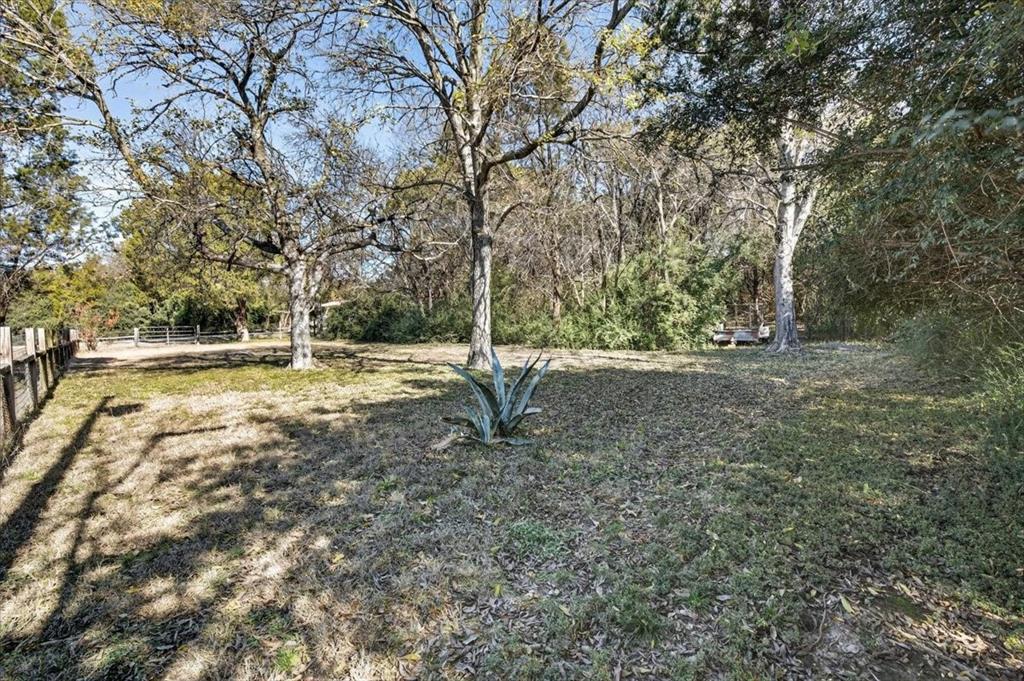 1706 Hitching Post Road Granbury, TX 76049 - Photo 32 of 40 a backyard of a house with lots of green space