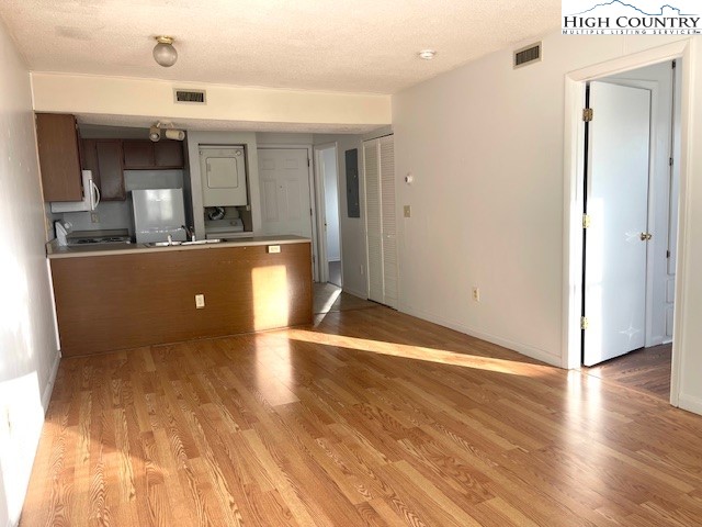 229 East King Street, Unit 27 Boone, NC 28607 - Photo 12 of 13 a view of a living room with wooden floor and a ceiling fan