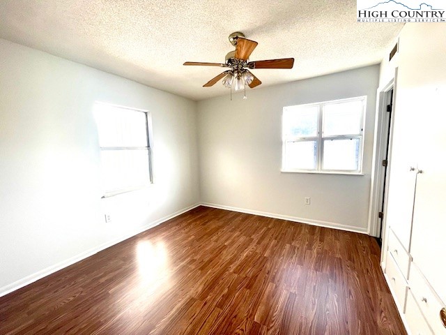 229 East King Street, Unit 27 Boone, NC 28607 - Photo 4 of 13 an empty room with wooden floor fan and windows