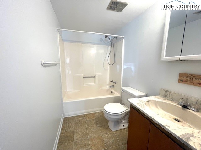 229 East King Street, Unit 27 Boone, NC 28607 - Photo 6 of 13 a bathroom with a granite countertop sink toilet and shower