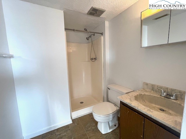 229 East King Street, Unit 27 Boone, NC 28607 - Photo 10 of 13 a bathroom with a granite countertop sink toilet and shower