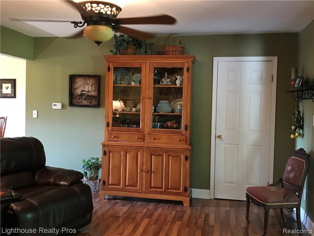 7150 Denton Hill Road Fenton, MI 48430 - Photo 15 of 47 Living room with updated ceiling fan and laminate floor