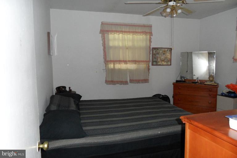 304 Charles Road Linthicum, MD 21090 - Photo 7 of 11 a bedroom with a bed and a chandelier