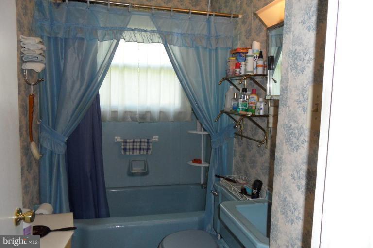 304 Charles Road Linthicum, MD 21090 - Photo 8 of 11 a bathroom with a tub and a shower