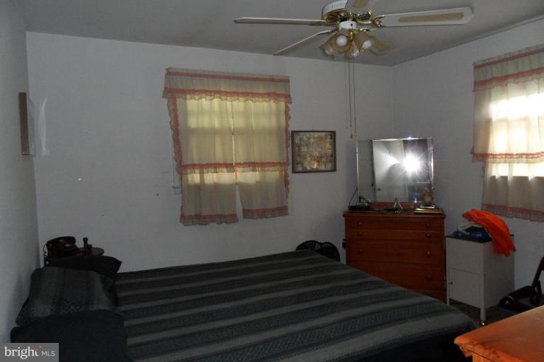 304 Charles Road Linthicum, MD 21090 - Photo 10 of 11 a bedroom with a bed and a chandelier fan