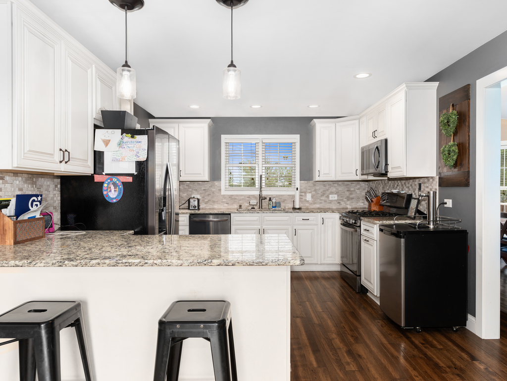 3964 East 2259th Road Serena, IL 60549 - Photo 13 of 36 a kitchen with stainless steel appliances granite countertop a sink refrigerator and cabinets