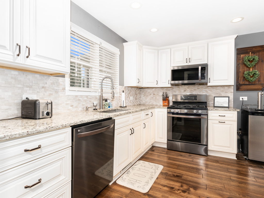 3964 East 2259th Road Serena, IL 60549 - Photo 15 of 36 a kitchen with granite countertop a sink and steel appliances