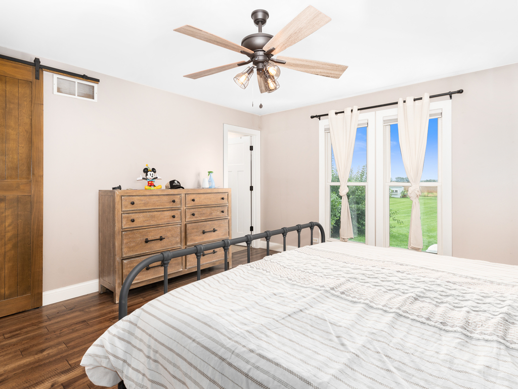 3964 East 2259th Road Serena, IL 60549 - Photo 16 of 36 a bedroom with a bed and a chandelier