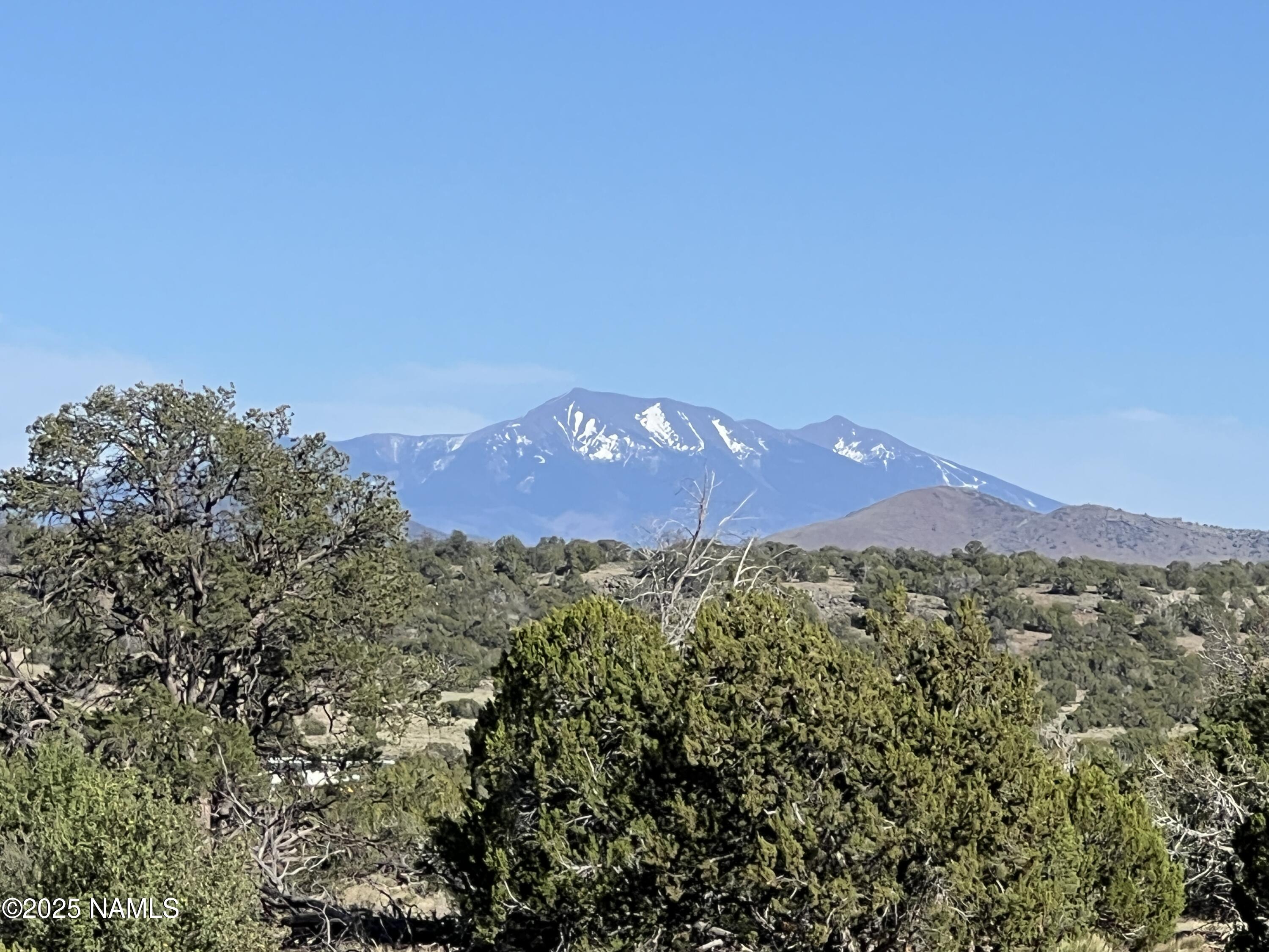 8755 South Rim Ranch Road Williams, AZ 86046 - Photo 3 of 9 a view of a city with a mountain in the background