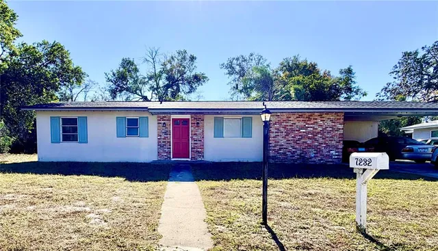 a front view of a house with a yard covered with snow in front of house