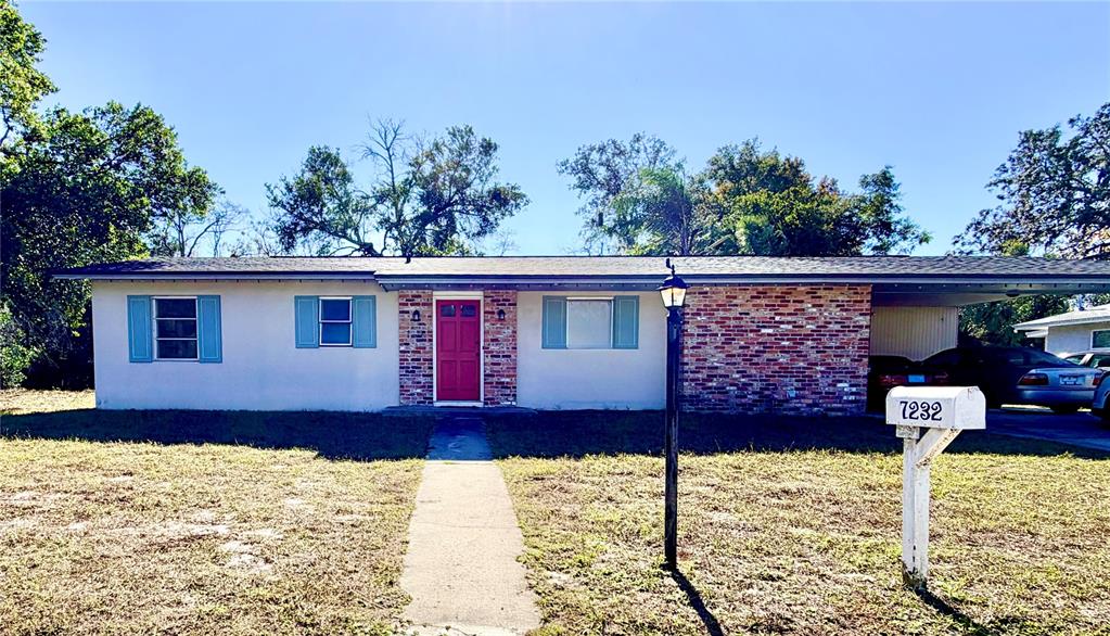 a front view of a house with a yard covered with snow in front of house