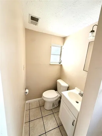 a bathroom with a toilet a sink and a mirror