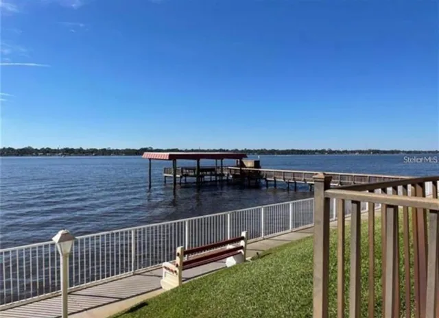 a view of a balcony with floor to ceiling window and wooden fence