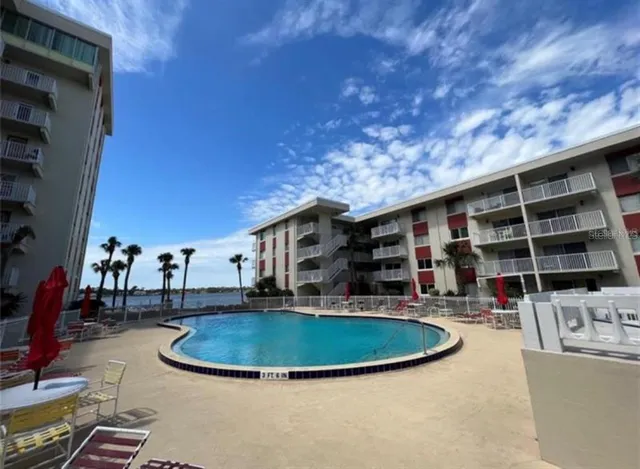 a view of a swimming pool with outdoor seating