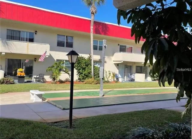 a view of a house with a yard and sitting area