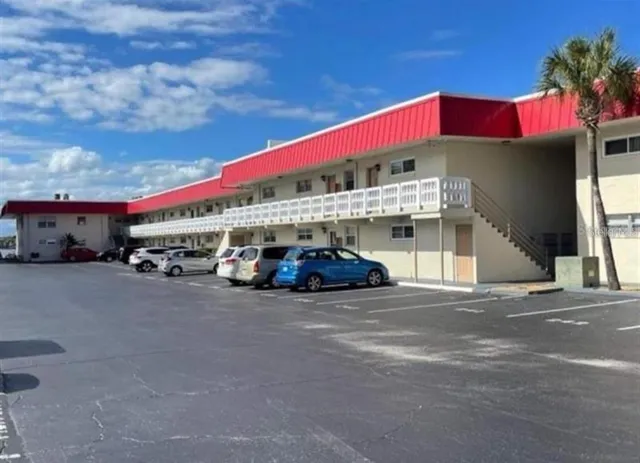a red car parked in front of a building