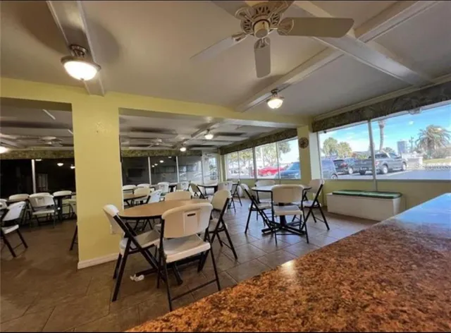 a living room with a table chairs and a swimming pool