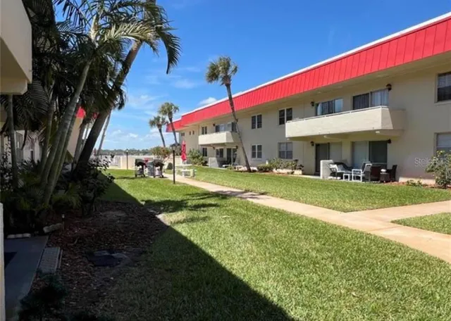 a view of a house with backyard and a patio