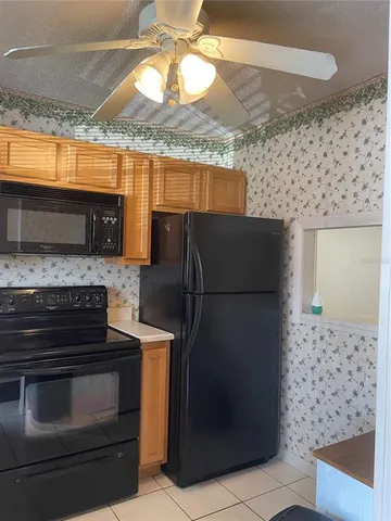 a kitchen with granite countertop a refrigerator and a stove
