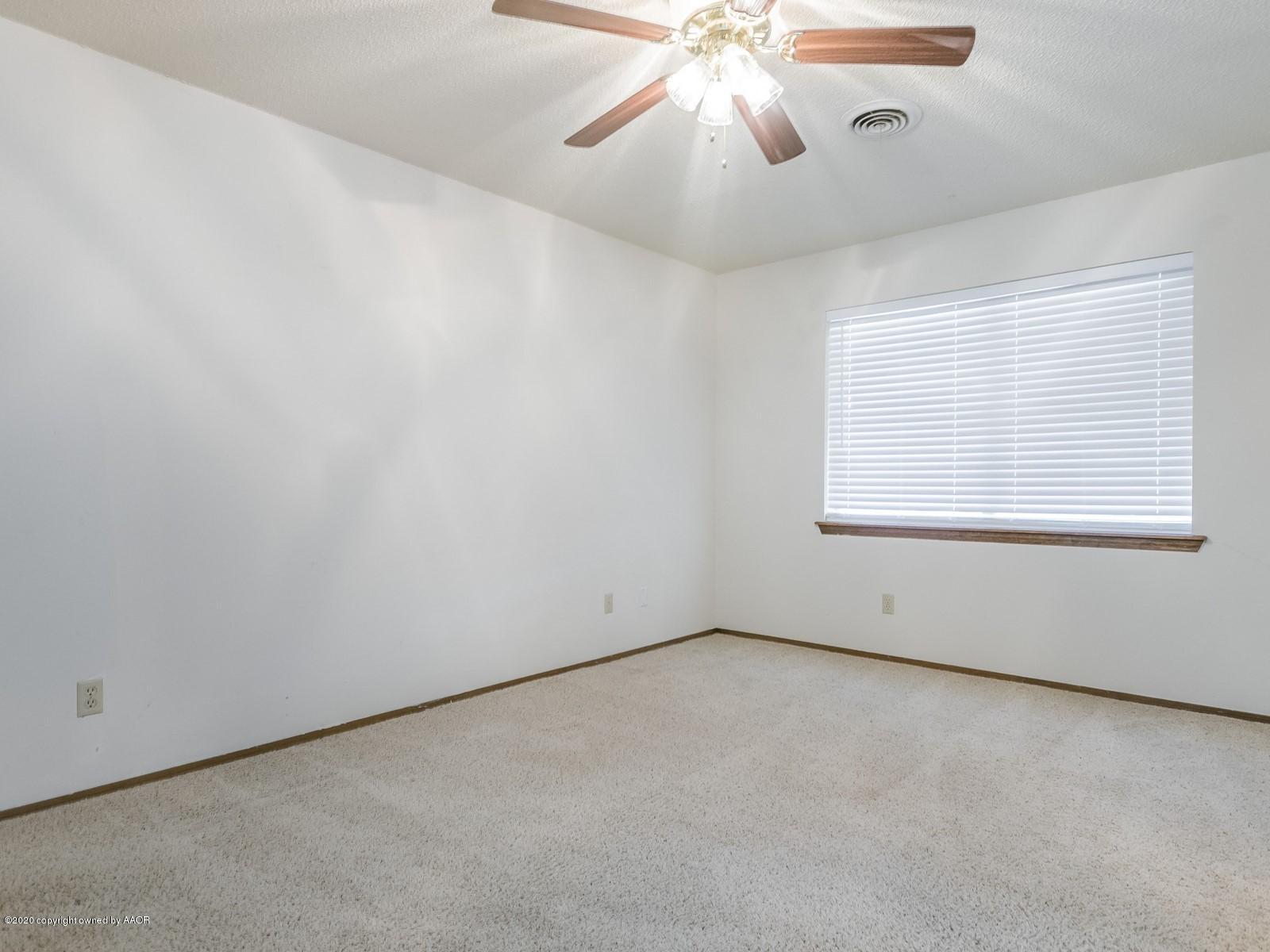 5301 South Milam Street Amarillo, TX 79110 - Photo 11 of 21 an empty room with a window and a fan