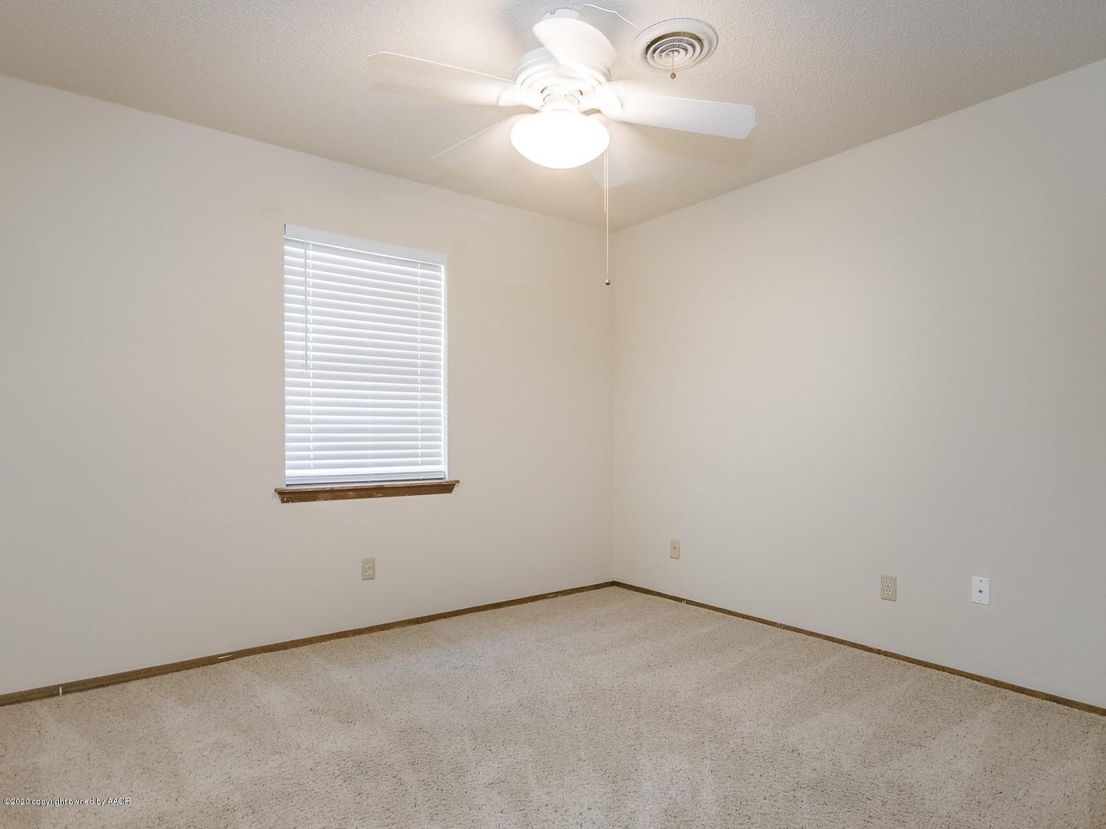5301 South Milam Street Amarillo, TX 79110 - Photo 15 of 21 an empty room with a window and a ceiling fan