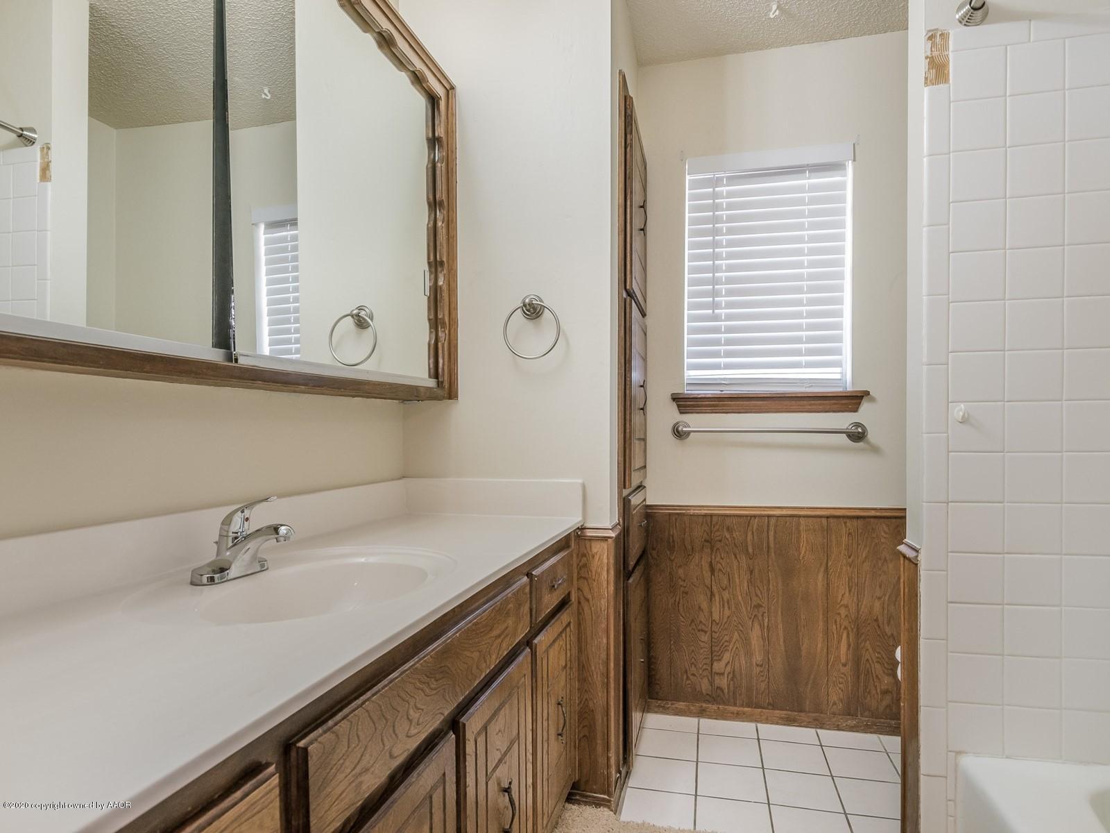 5301 South Milam Street Amarillo, TX 79110 - Photo 16 of 21 a bathroom with a sink and a mirror