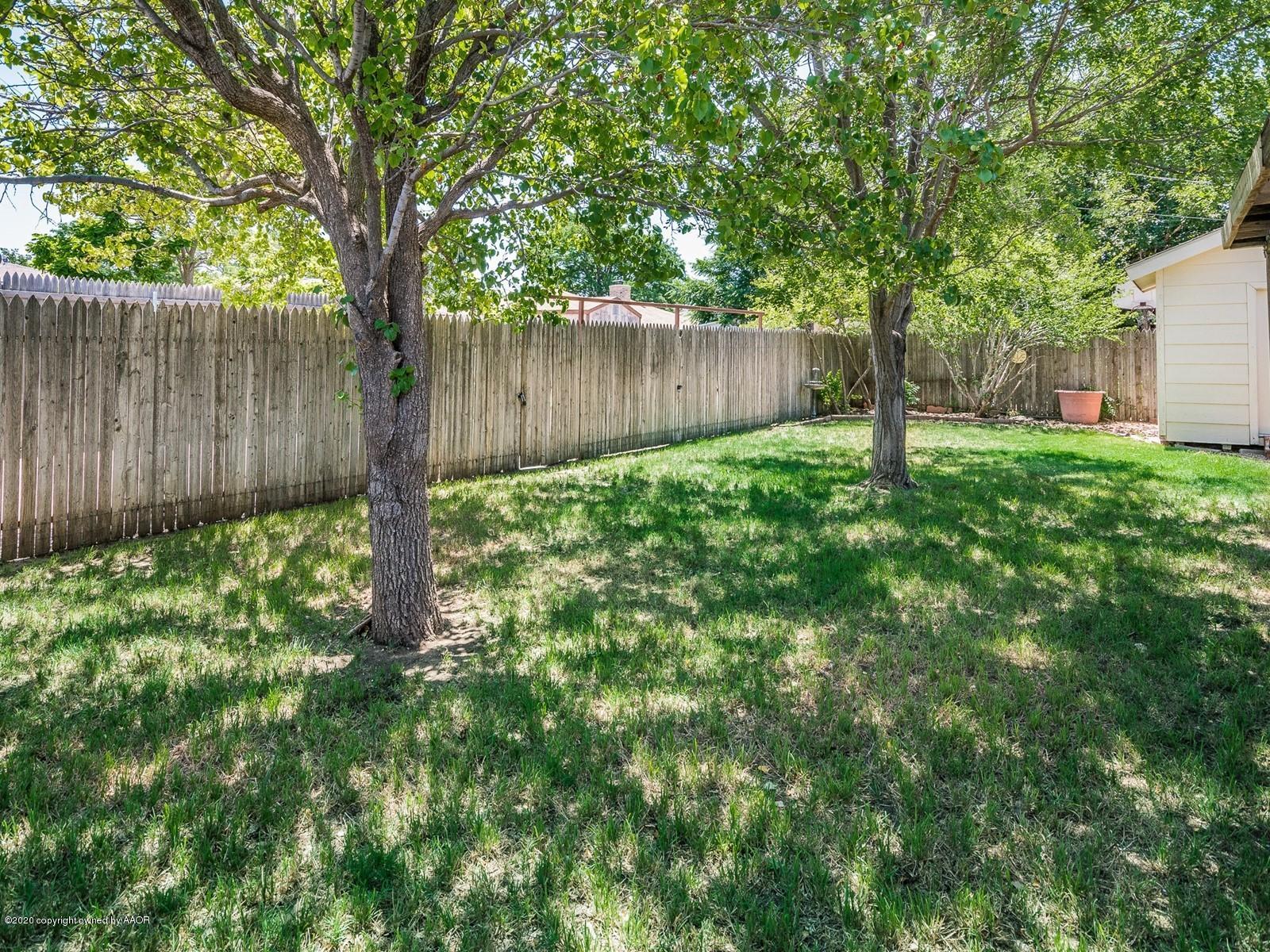 5301 South Milam Street Amarillo, TX 79110 - Photo 19 of 21 a view of a yard with large trees and wooden fence