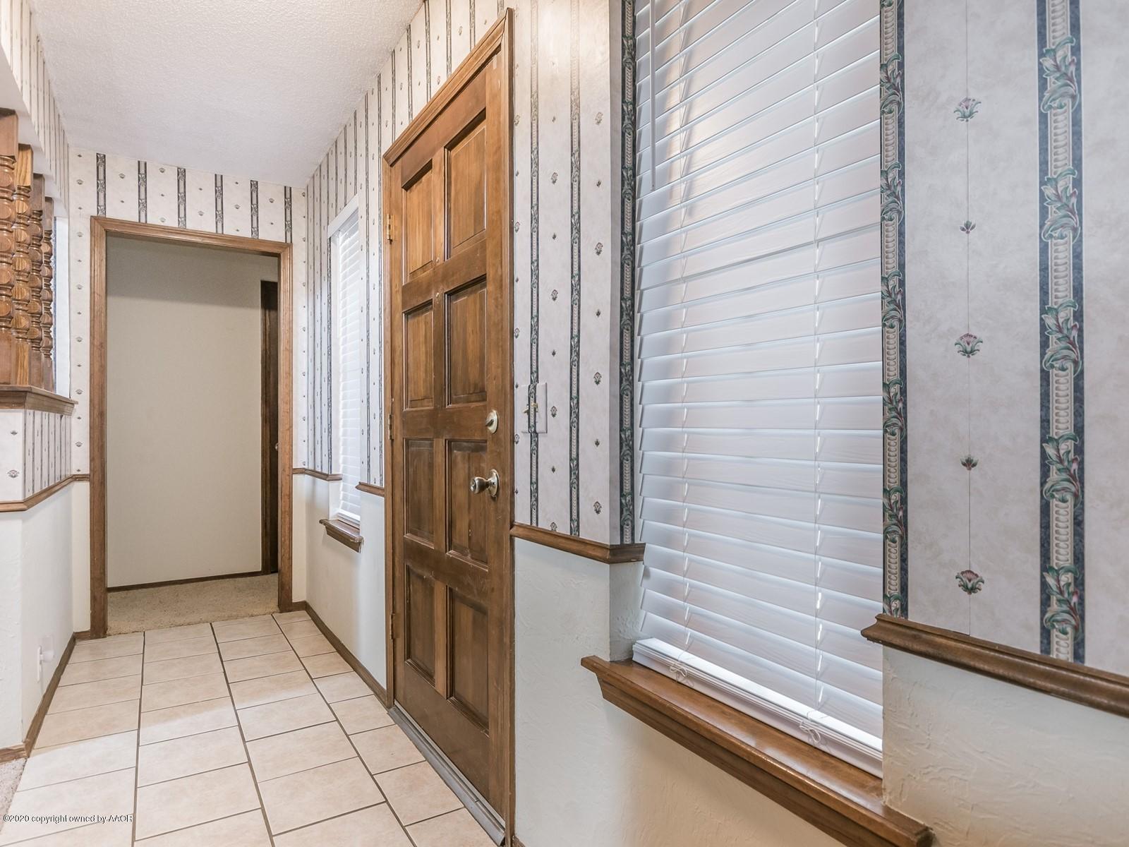5301 South Milam Street Amarillo, TX 79110 - Photo 3 of 21 a view of a refrigerator in kitchen and an empty room