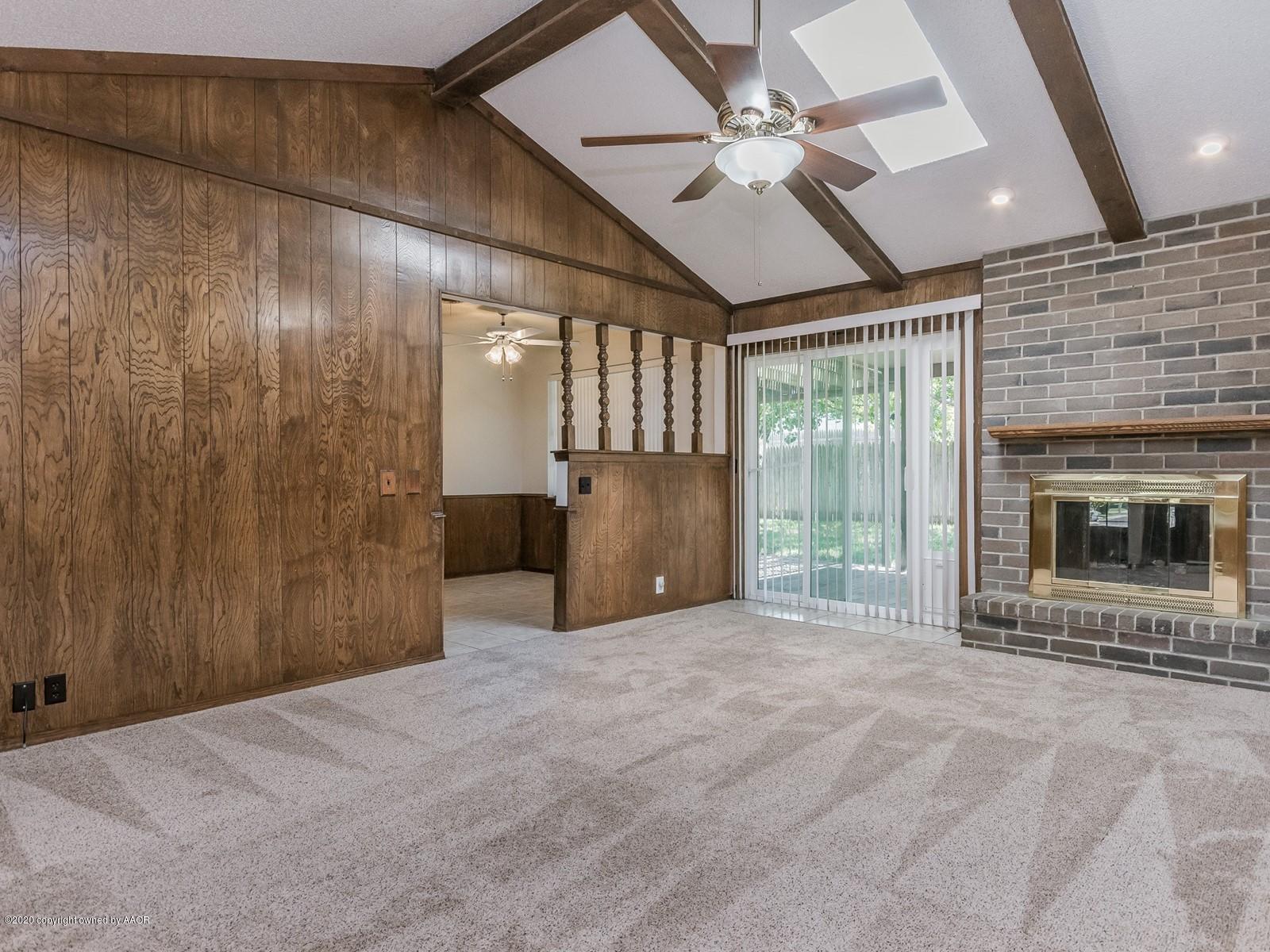 5301 South Milam Street Amarillo, TX 79110 - Photo 4 of 21 a view of an empty room with a fireplace and a large window