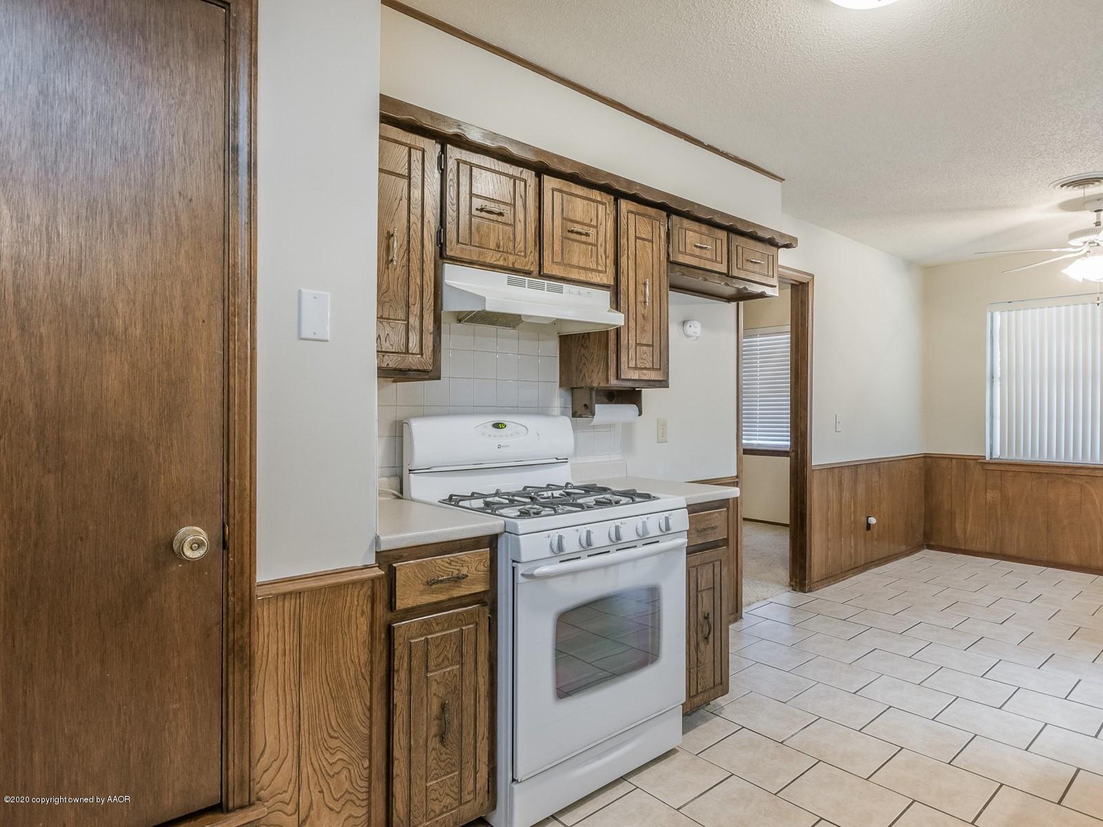 5301 South Milam Street Amarillo, TX 79110 - Photo 8 of 21 a kitchen with stainless steel appliances granite countertop a stove a sink and a refrigerator