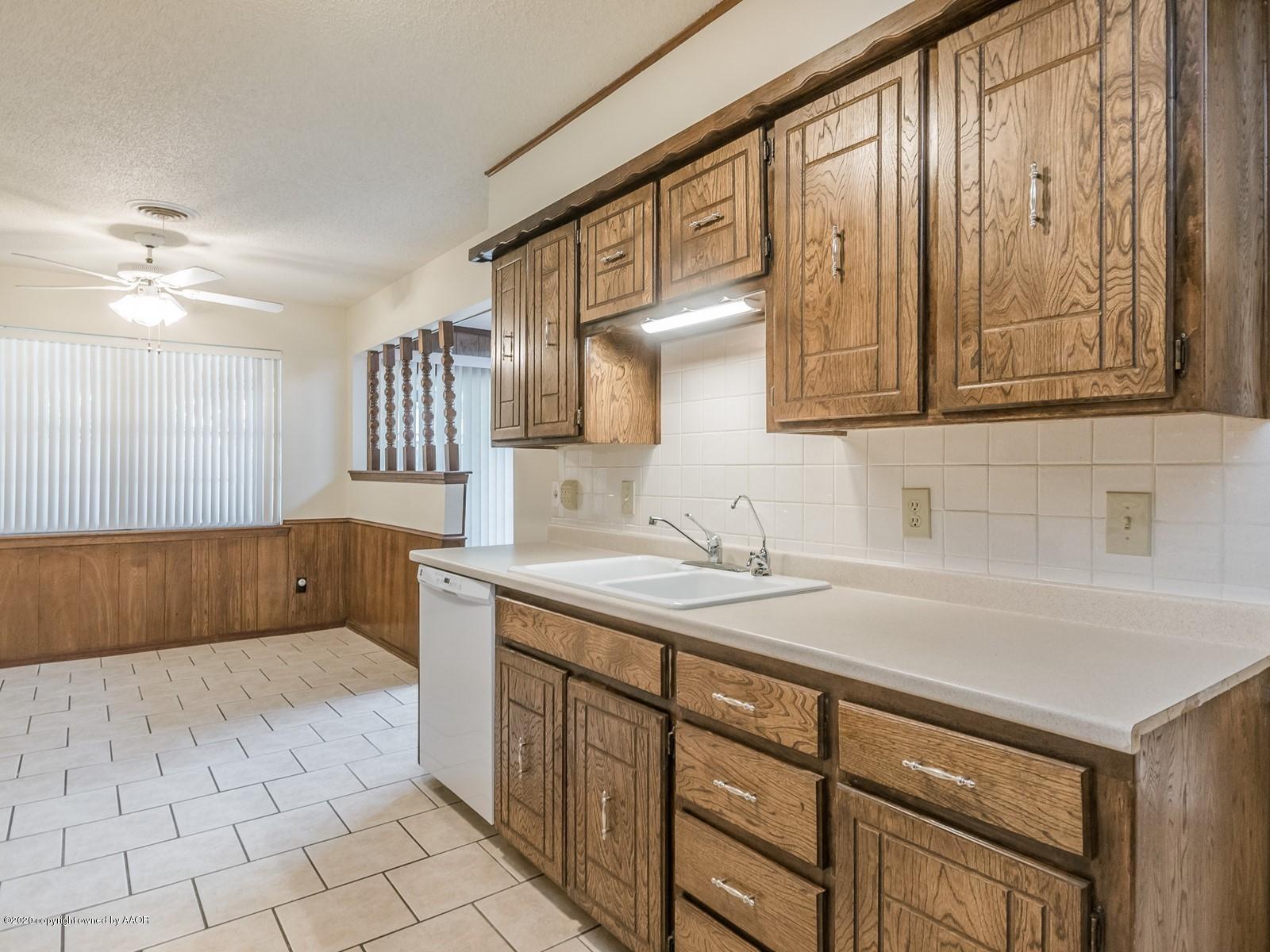 5301 South Milam Street Amarillo, TX 79110 - Photo 9 of 21 a kitchen with a sink cabinets and window