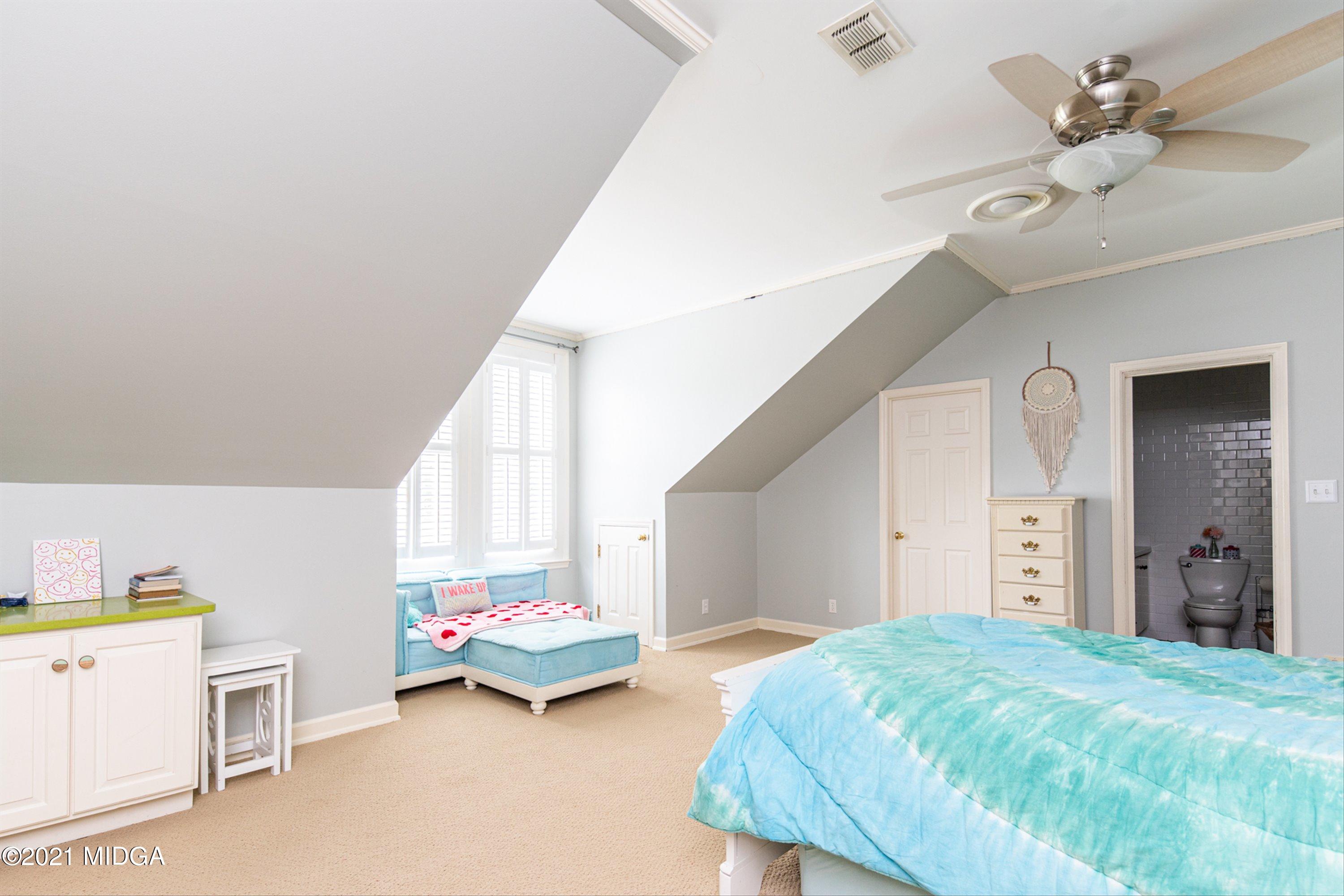 6261 Forsyth Road Macon, GA 31210 - Photo 40 of 77 a bedroom with a bed and a chandelier