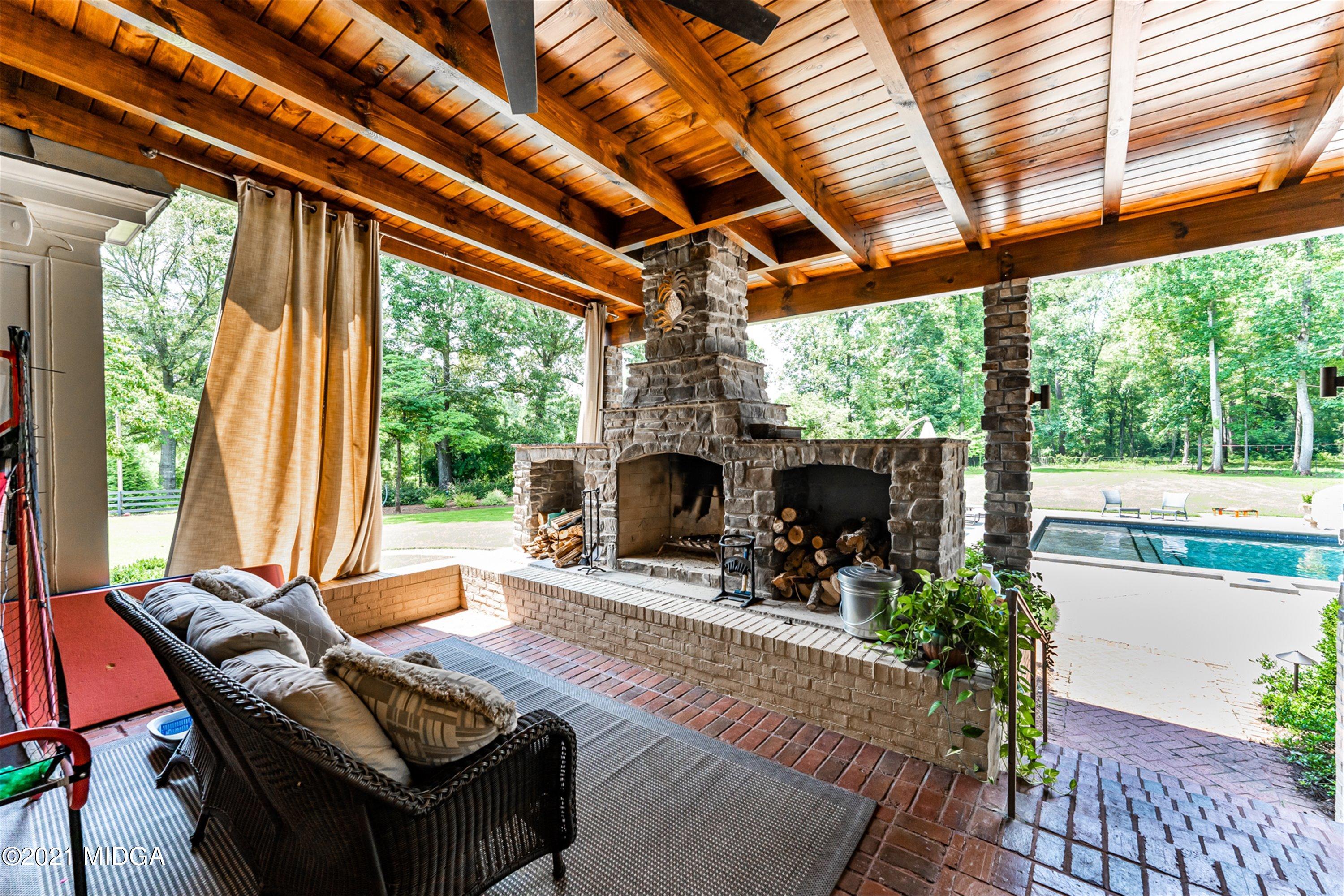 6261 Forsyth Road Macon, GA 31210 - Photo 50 of 77 a outdoor living space with furniture and a fireplace