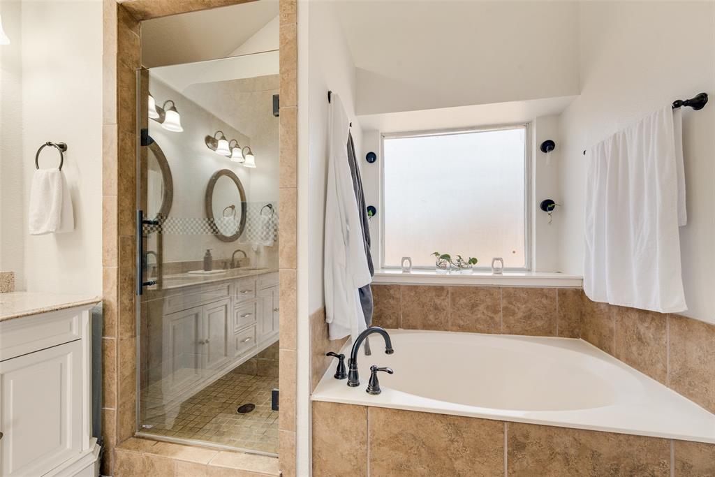 106 Villanova Circle Forney, TX 75126 - Photo 17 of 26 a bathroom with bathtub shower and mirror