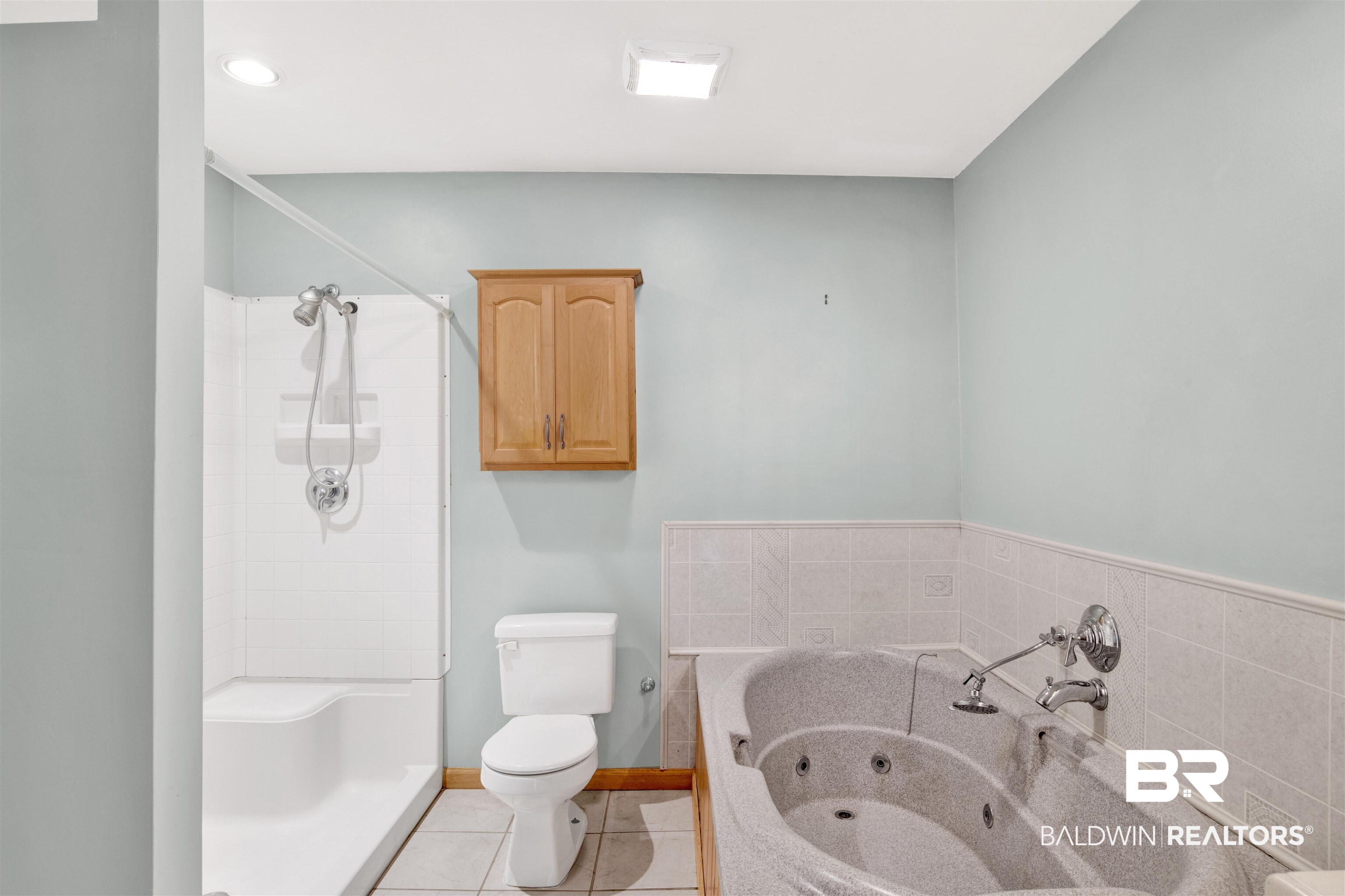 7411 Bay Road Mobile, AL 36605 - Photo 21 of 34 Bathroom featuring light tile patterned floors, a whirlpool tub, and a stall shower