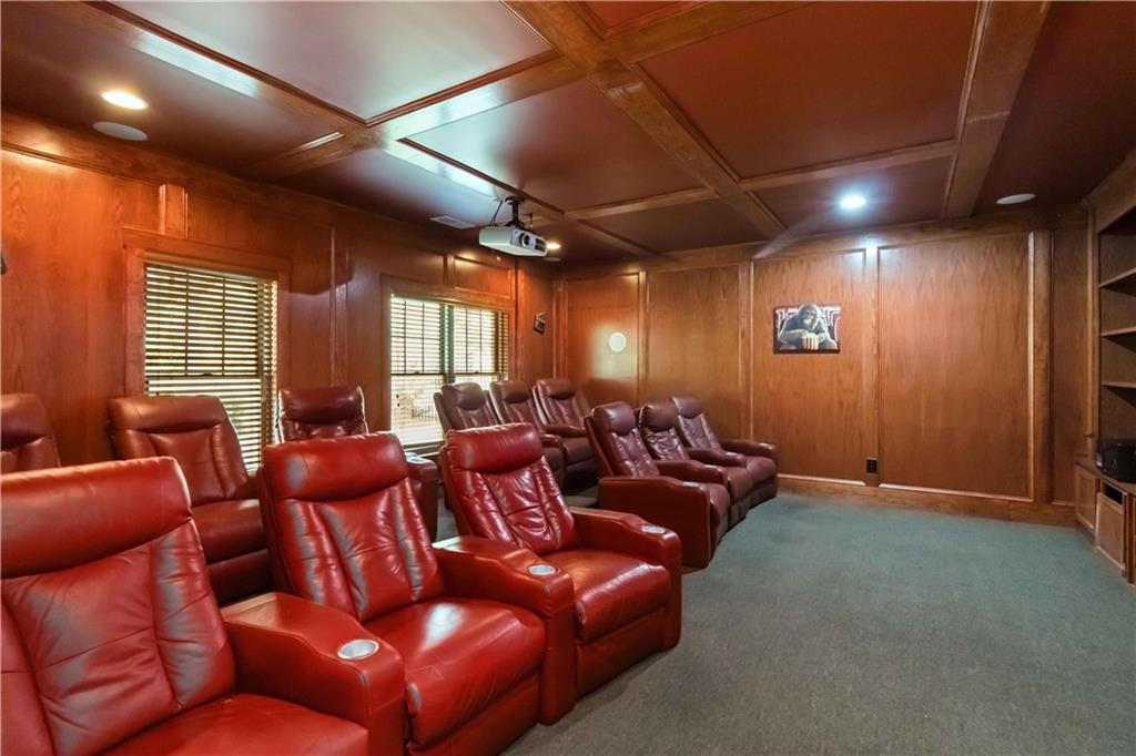 3320 Spencer Street Cumming, GA 30041 - Photo 39 of 70 a media room with lots of chairs and a projector screen