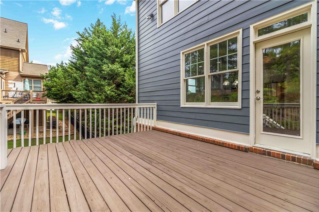 3320 Spencer Street Cumming, GA 30041 - Photo 46 of 70 a view of a wooden deck with a yard