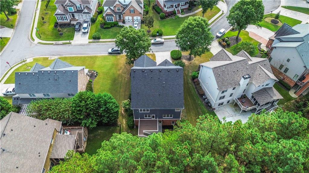3320 Spencer Street Cumming, GA 30041 - Photo 64 of 70 an aerial view of a house with a garden space and a large pool
