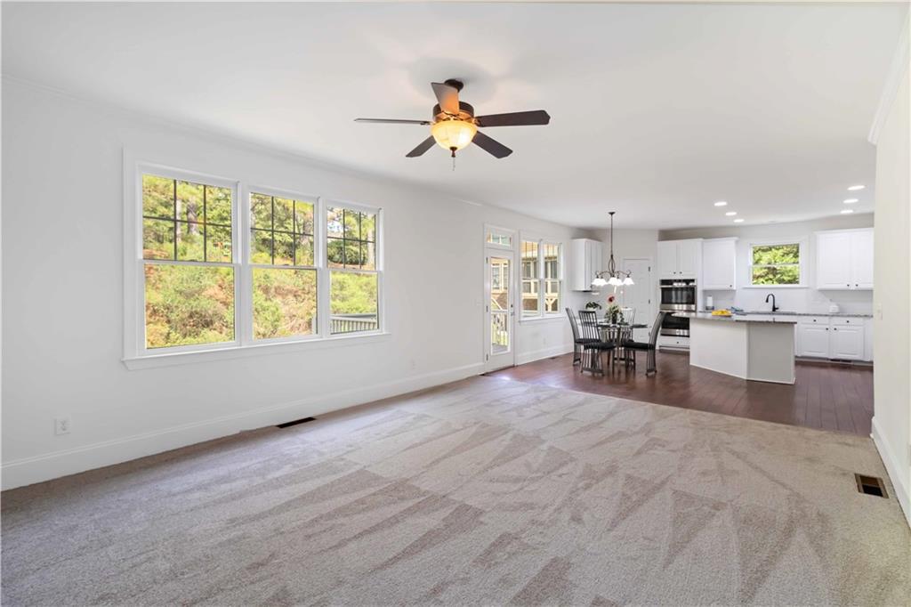 3320 Spencer Street Cumming, GA 30041 - Photo 10 of 70 a view of a livingroom with furniture ceiling fan and window