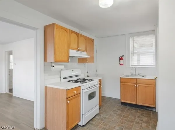 a kitchen with stainless steel appliances a stove sink and cabinets