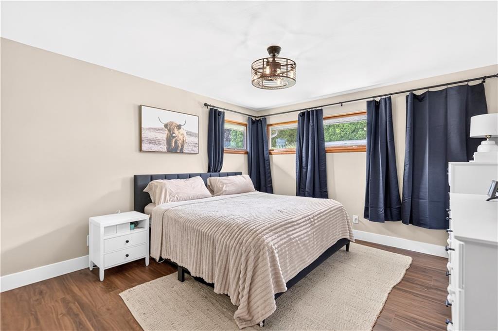 1642 Rostraver Road Belle Vernon, PA 15012 - Photo 13 of 32 a bedroom with a large bed and a chandelier