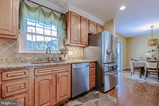a dining room with furniture window and wooden floor
