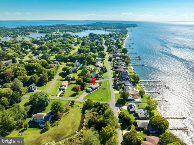 an aerial view of a house with a garden and lake view