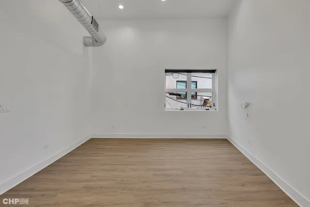 a view of room with hardwood floor and window