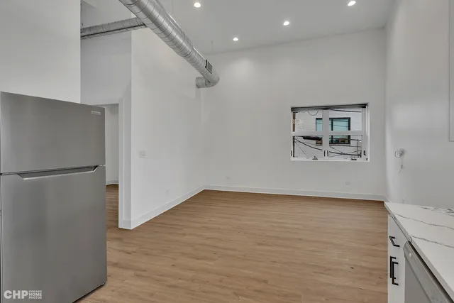 a view of a refrigerator in kitchen and wooden floor